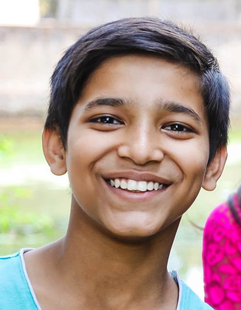 A boy smiling for the camera.